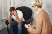 мужчина разговаривает с доктором о лечении игровой зависимости